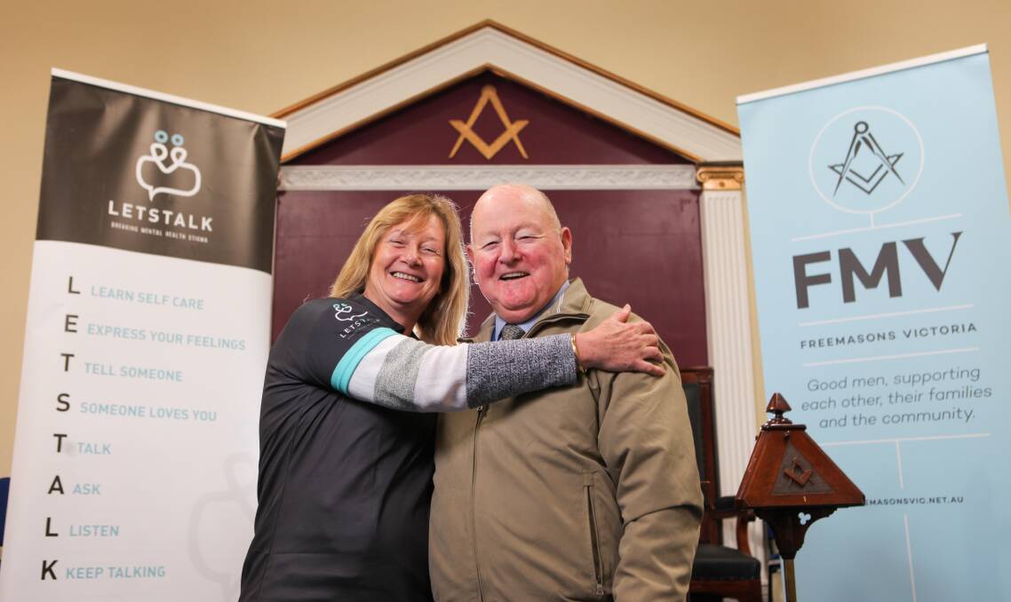 Thank you: Let's Talk board of directors member Claire Brown gives Masonic Lodge secretary Bob Pullin a hug after a $55,000 donation. Picture: Rob Gunstone
