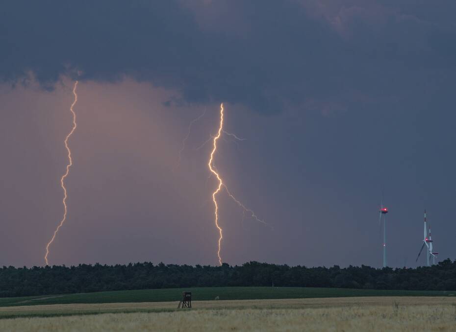 Lightning strikes overnight near wind turbines in Treplin, Germany.