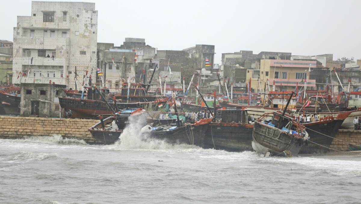 Fishing boats are forced onto a wall due to heavy winds and huge waves in the Arabian sea at Veraval, India overnight. A cyclone in the Arabian Sea battered the Indian fishing hub.