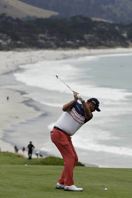 SCENIC: Australia's Marc Leishman hits from the fairway on the ninth hole during the first round of the US Open in Pebble Beach, California. Picture: AP Photo/Marcio Jose Sanchez