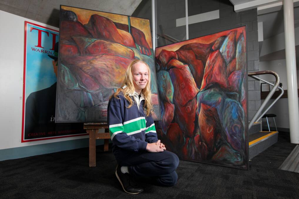 Family Link: Warrnambool College student Finn Stratford, 15, with the two paintings by his grandmother Noela Stratford that were found under one of the school's buildings. Picture: Rob Gunstone