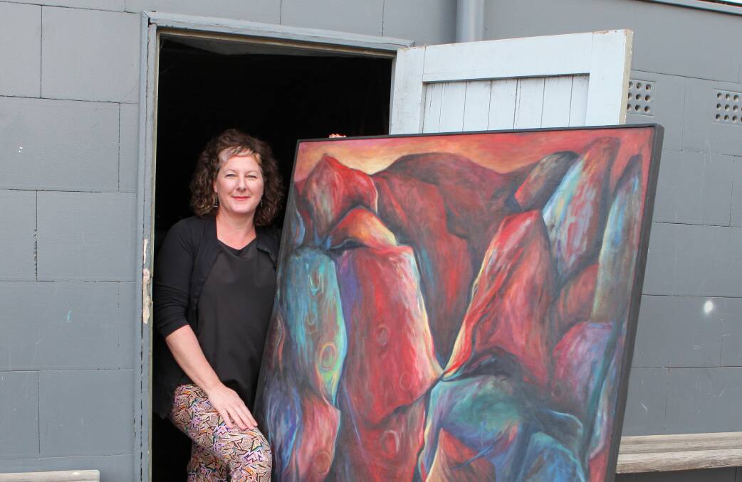 Uncovered: Warrnambool College art teacher Anthea Rafferty with the artwork by Noela Stratford that was found under one of the school's buildings. Picture: Rob Gunstone