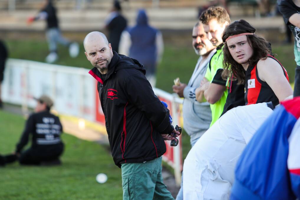 HELPING OUT: Injured coach Danny Chatfield stands on the East Warrnambool bench on Saturday. Picture: Morgan Hancock