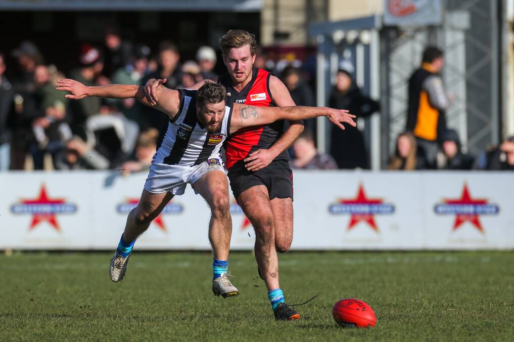 FLYING IN: Camperdown's Tim Fitzgerald does his best bomber impersonation in front of Cobden's Luke Pekin on Saturday. Picture: Rob Gunstone