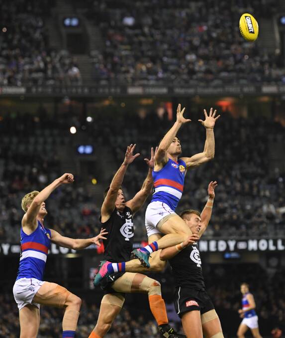 HIGH FLYER: Easton Wood jumps for a mark against Carlton in round 13 of the 2019 season. Picture: AAP Image/Julian Smith