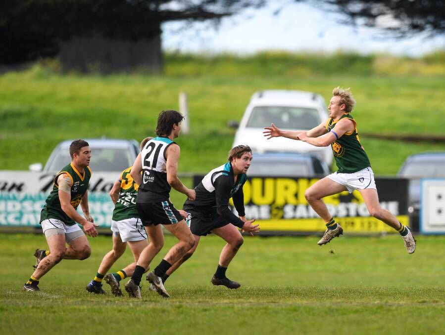 Match day: Ben Turner-Dwyer (extreme left) and Old Collegians' Bodie Hibberson (extreme right) during the match with Kolora-Noorat on Saturday. Picture: Morgan Hancock