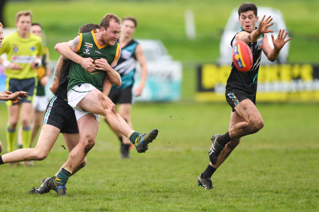 Wrapped up: Old Collegians' Colby Rix gets the ball away under pressure in his side's loss to Kolora-Noorat. Picture: Morgan Hancock