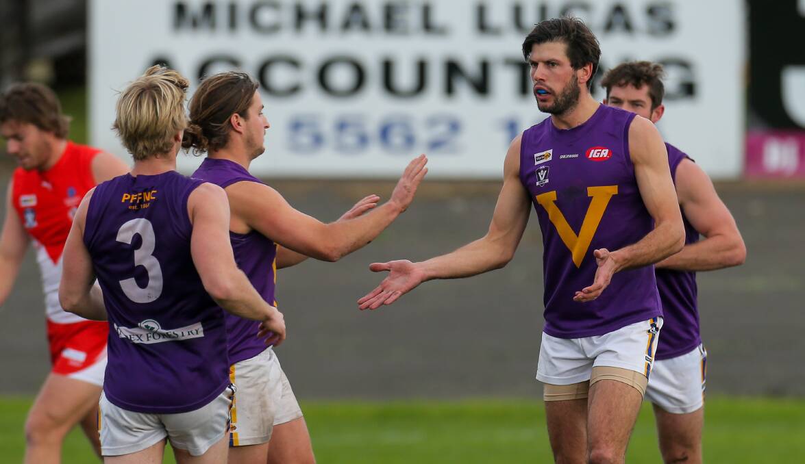 HIGH FIVES: Port Fairy players get around Sandy Robinson after his first quarter goal. Picture: Rob Gunstone