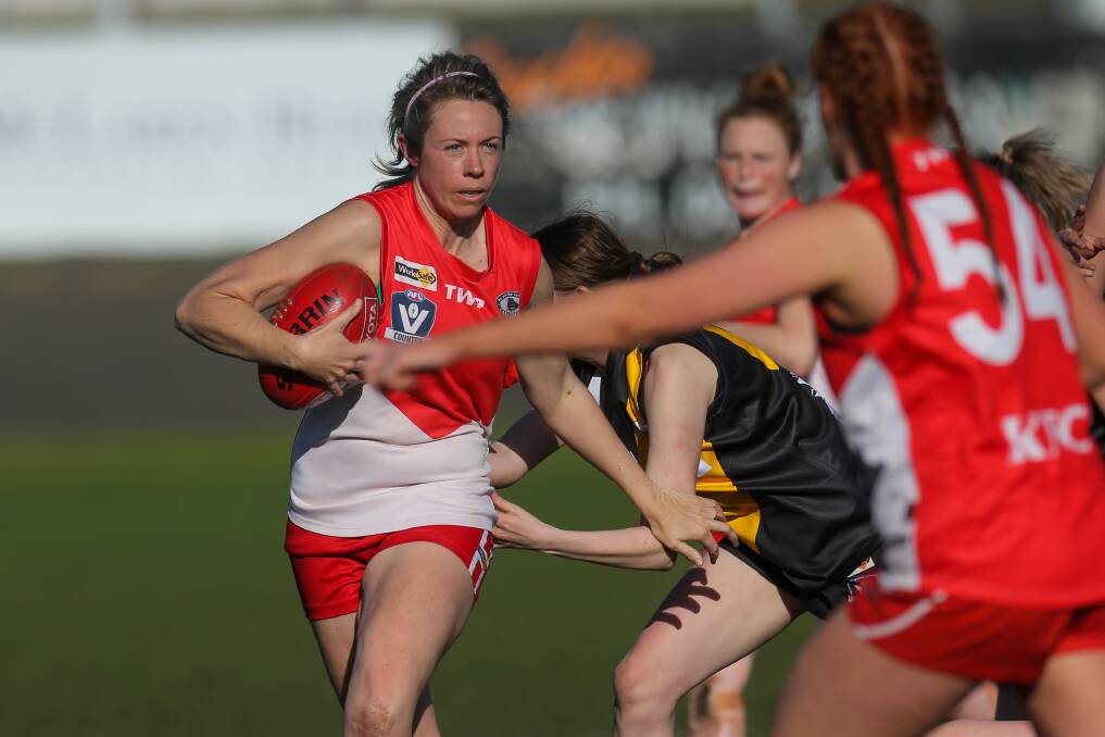 Contest: South Warrnambool's Skye McPherson tries to slip a Portland tackle. Picture: Rob Gunstone