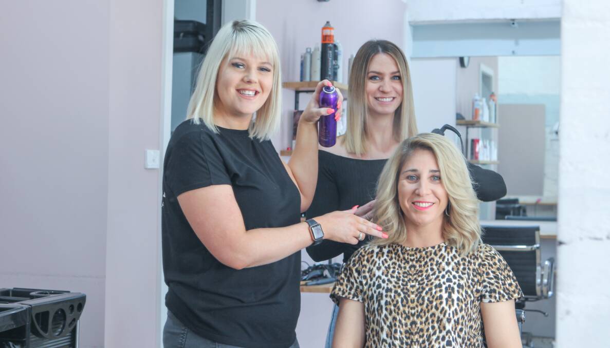 ON THEIR WAY: Salt Hair Port Fairy's Haylee Henderson and Jessica James are off to to help style the Miss Universe competition. They are pictured here with Salt Hair Port Fairy owner Vicki Hetherington (seated). Picture: Rob Gunstone.