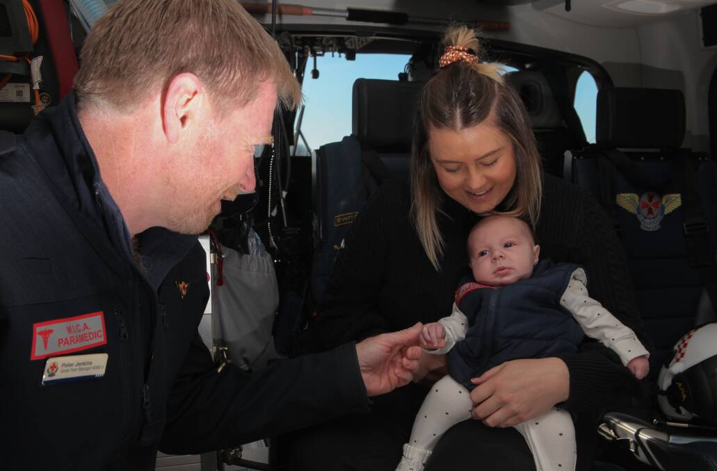 Peter Jenkins talks to one of his patients, Amanda Gibbins, and her eight-week-old baby Jagger. Picture: Mark Witte