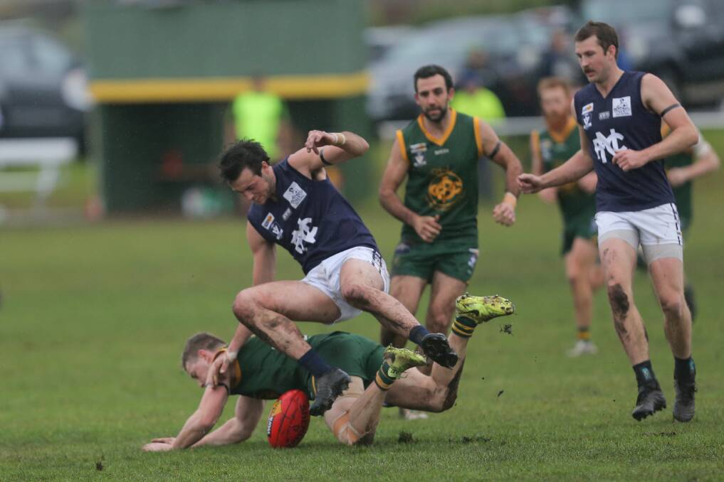 Slip and slide: Nirranda's Mathew Lloyd lands on the back of Old Collegians coach Nick Sheehan. Picture: Mark Witte