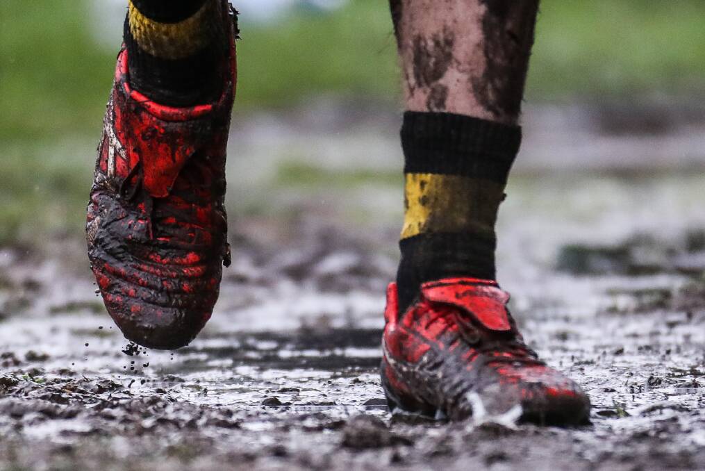 TOUGH SLOG: A Portland player navigates through the mud against Port Fairy in a weather-impacted game at Gardens Oval before the bye. Picture: Morgan Hancock
