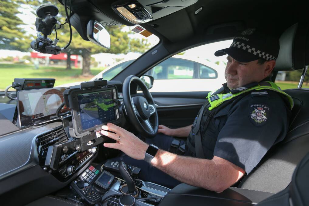 On the road: Senior Constable Corey Holland demonstrates how the automatic number plate recognition installed in the Victorian Police vehicles. Picture: Mark Witte