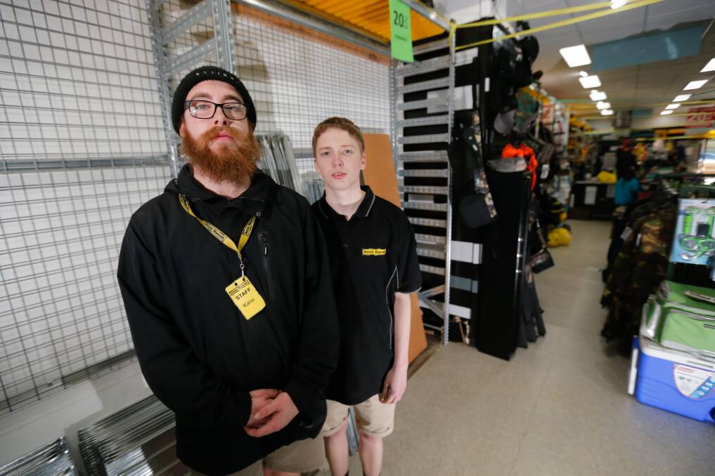 EMPTY SHELVES: Workers Kane Clarke and Jayden Gipp will be out of work when the store closes it's doors. Picture: Mark Witte