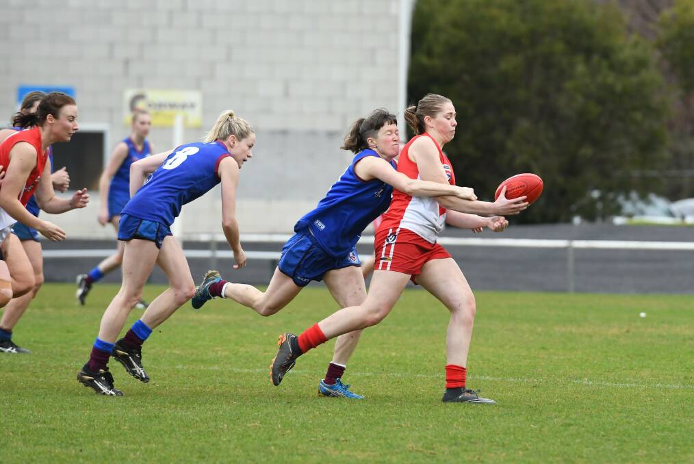 Defence: South Warrnambool's Kelsey Perry is tackled by Horsham Demons' Sophie Robinson. Picture: Jade Bate