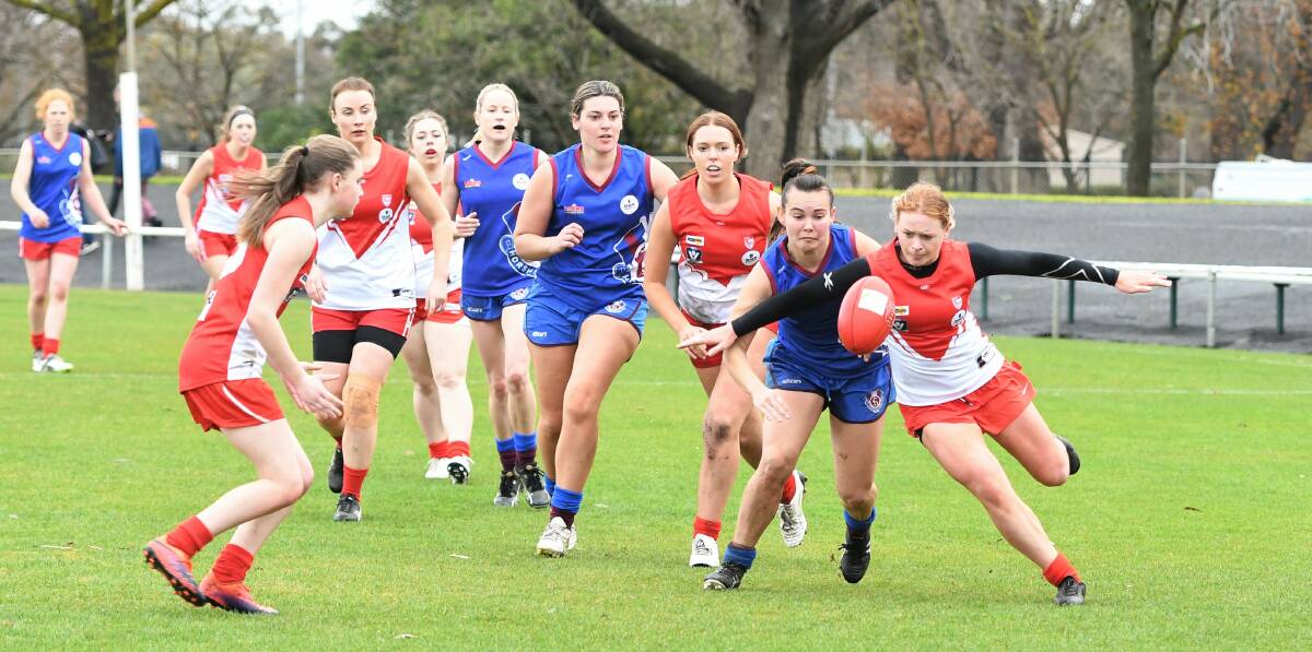 JOSTLING FOR POSSESSION: Horsham Demons' Kate McLean and South Warrnambool's Jane McMeel fight for the ball on Sunday. Picture: Jade Bate