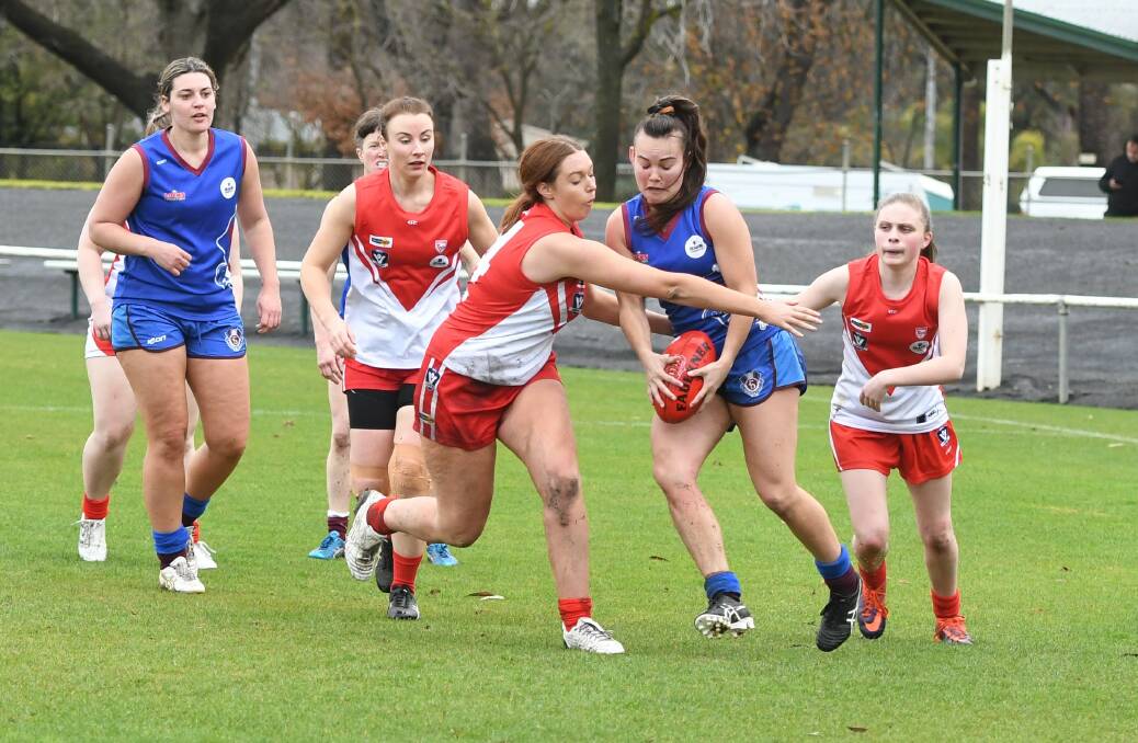 GOTCHA: South Warrnambool's Laura De Bolfo and Horsham Demons' Kate McLean battle for the ball at Horsham City Oval on Sunday. Picture: Jade Bate