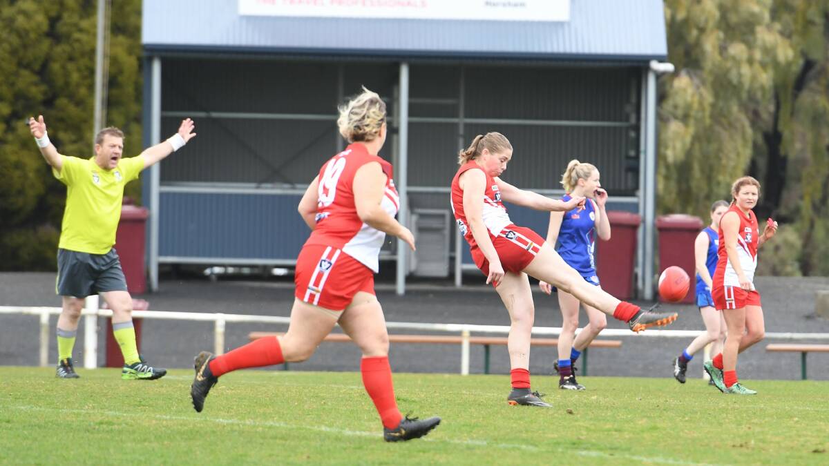 Bang: South Warrnambool's Kelsey Perry gets a quick kick away against Horsham Demons. Picture: Jade Bate