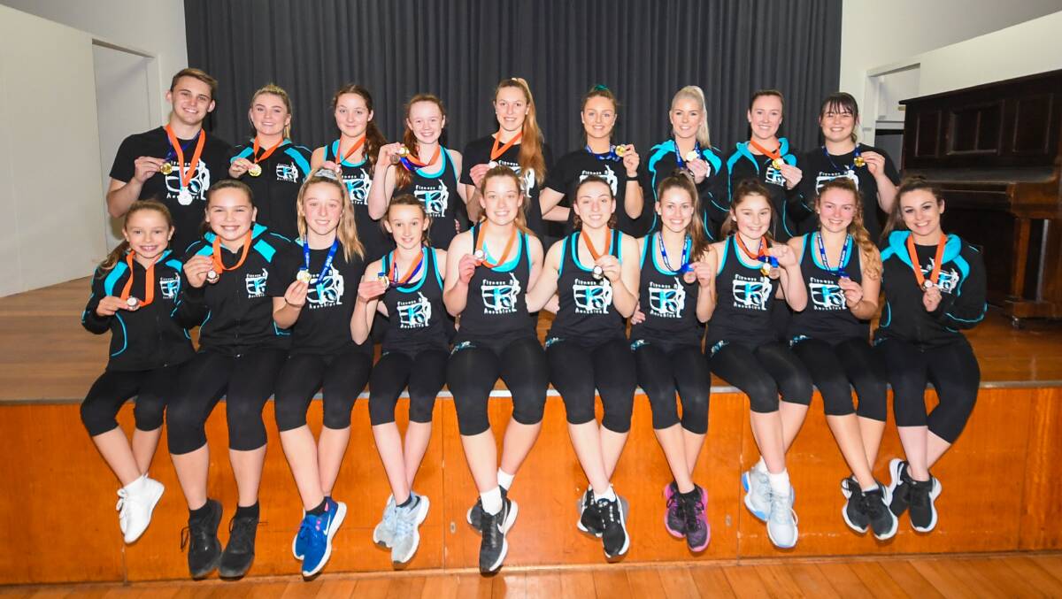 HAUL: Warrnambool EKB Fitness and Aerobics squad show off the medals they won at the state championships. Picture: Sean Hardeman