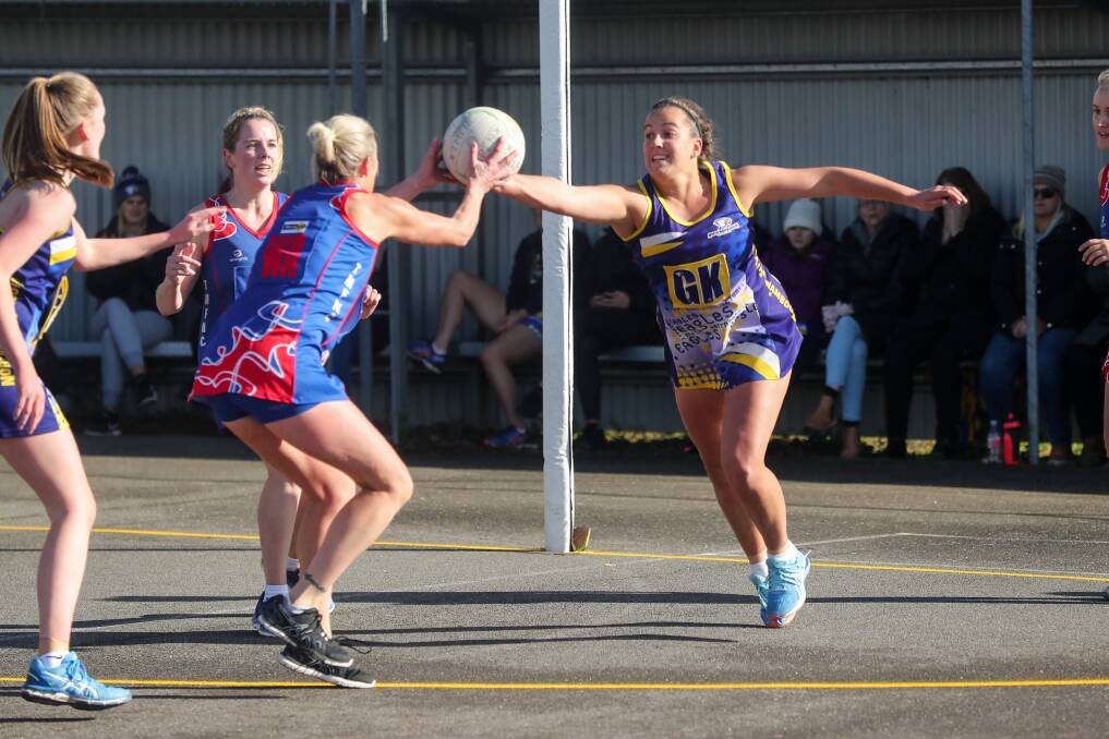 Hanging on: Terang-Mortlake's Faye Clarke takes the ball as North Warrnambool's Jordyn Billings charges out. Picture: Rob Gunstone