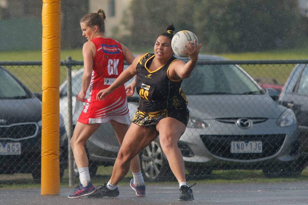 WINTRY WEATHER: Merrivale's Tanaya Harradine reaches to catch the ball as rain tumbles at Merrivale Recreation Reserve on Saturday. Picture: Mark Witte