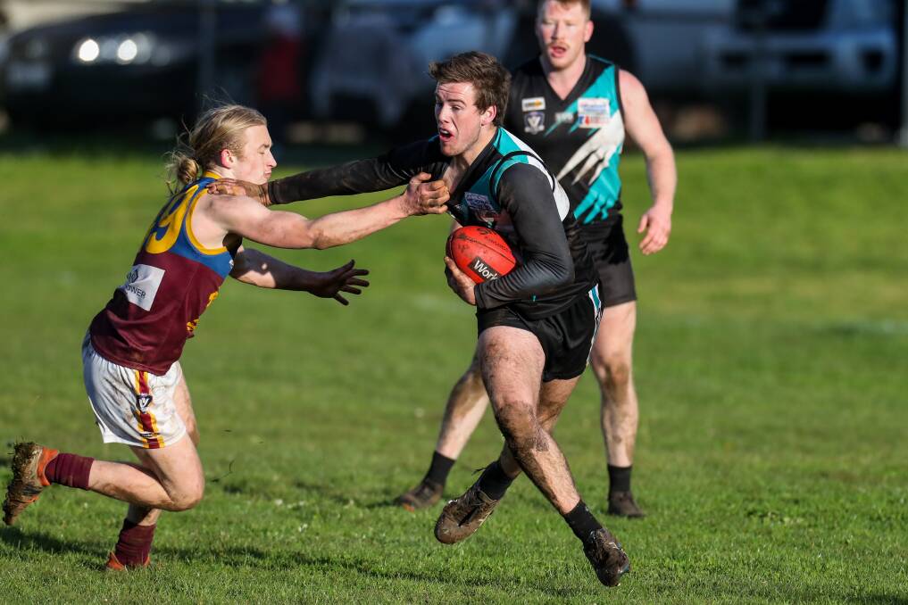 DON'T ARGUE: South Rovers' Eamon Dowd receives a fend off from Kolora-Noorat's Luke Justin at Noorat Recreation Reserve on Saturday. Picture: Rob Gunstone
