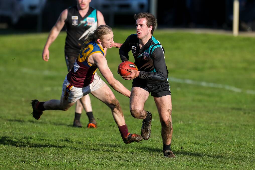 Kolora-Noorat's Luke Justin evades Eamon Dowd from South Rovers. Picture: Rob Gunstone