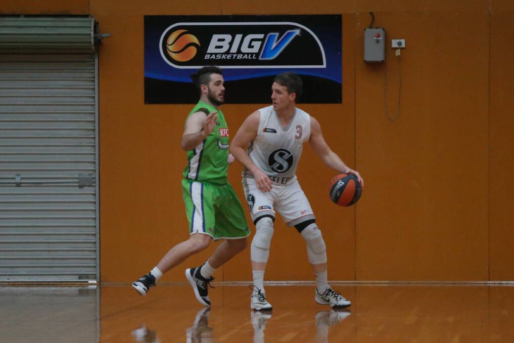 HANDY OPPONENR: Western Port Steelers' Daryl Corletto, who played NBL, goes up against Warrnambool Seahawks' Josh Dean. Picture: Mark Witte