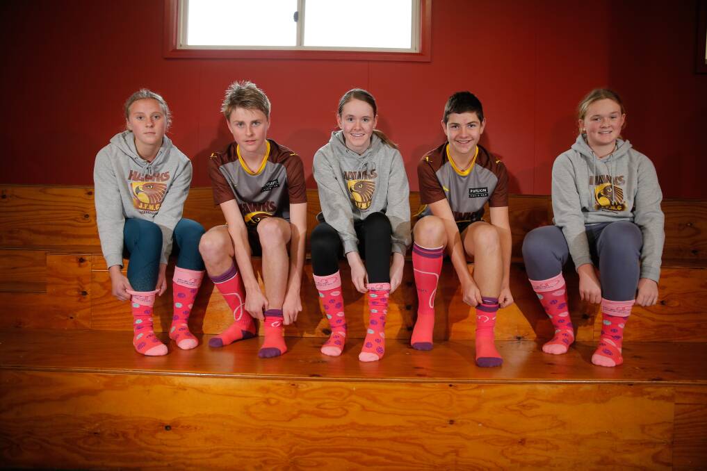 PULL YOUR SOCKS UP: Hawks' players Jenna Cahill, 15, Will Owen, 15, Emma McLaren, 14, Jack Ryan, 16, and Georgia Barton, 12, will support the McGrath Foundation on Sunday. Picture: Mark Witte