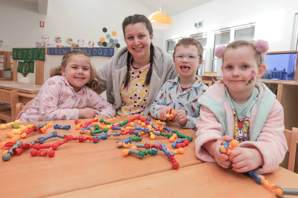Not Bed Time Yet: Koala Childcare Centre kindergarten students Pia Spicer, 5, Jimmy Hughes, 5, and Amelee Boyle, 5, and assistant teacher Rebecca Ingram are ready for bed and for National Pyjama Day. Picture: Rob Gunstone