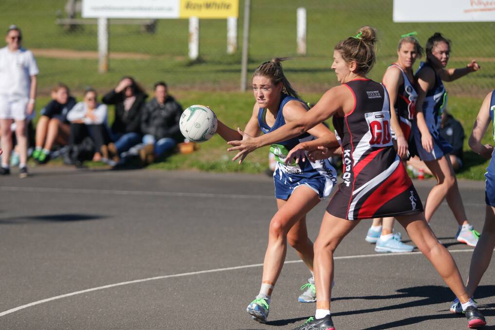 Finals time: Warrnambool's Amy Wormald passes around Koroit's Kasey Owen. The Blues and Saints will meet in a qualifying final. Picture: Mark Witte