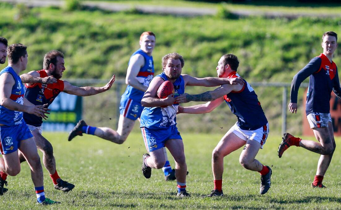 Bursting through: Panmure's Ben Robertson attempts to shrug off a Timboon Demons opponent. Picture: Anthony Brady