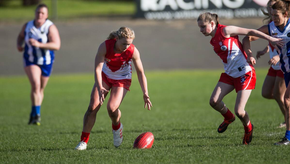 GROUND BALL: South Warrnambool player Jane McMeel reaches to pick up the ball. Picture: Anthony Brady