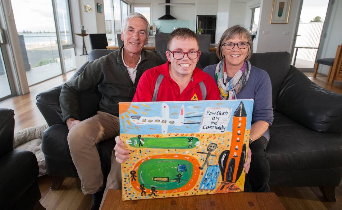 TALENT: Port Fairy artist Tommy Leembruggen with his painting for the cover of the Moyneyana Festival program. He is with his parents David and Denise. Picture: Anthony Brady