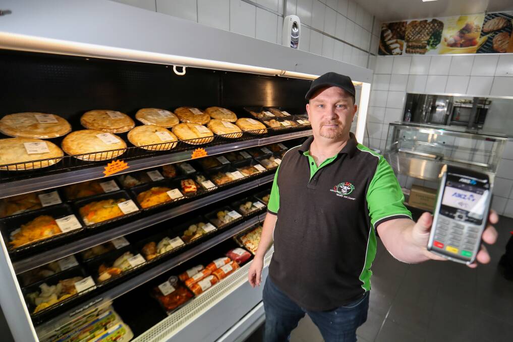 CASH NO LONGER KING: Warrnambool Country Meats owner David Wiese shows off the card machine that he will be using in store when they go cash-less. Picture: Morgan Hancock