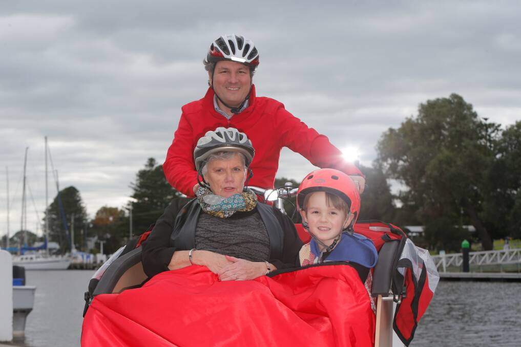 NEW PROJECT: Brendan Donahoo gives Lynda Hughes and Julian Donahoo, 4, a lift in the new cycling without age bicycle. Picture: Mark Witte