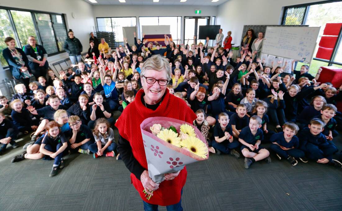 THANK YOU: Koroit and District Primary School crossing supervisor Susan Hand celebrates 10 years on the job with flowers from students and staff. Picture: Anthony Brady