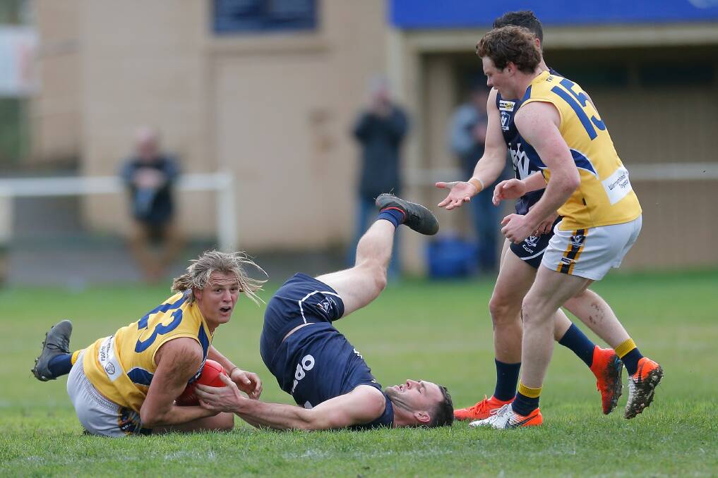 OUCH: Warrnambool's Thomas Ludeman (middle) tries his best to take the ball off North Warrnambool Eagles' Sam McLachlan. Picture: Mark Witte