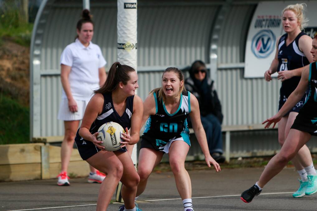 Turn and shoot: Sophie Adams grabs the ball while Holly Richardson closes in. Picture: Anthony Brady
