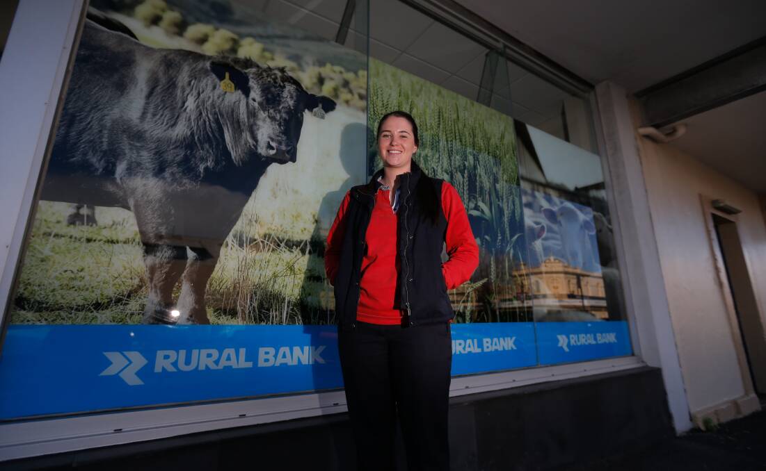 HELLO: Annie Giblin is all smiles in front of the Rural Bank in Warrnambool, her new place of employment. Picture: Mark Witte