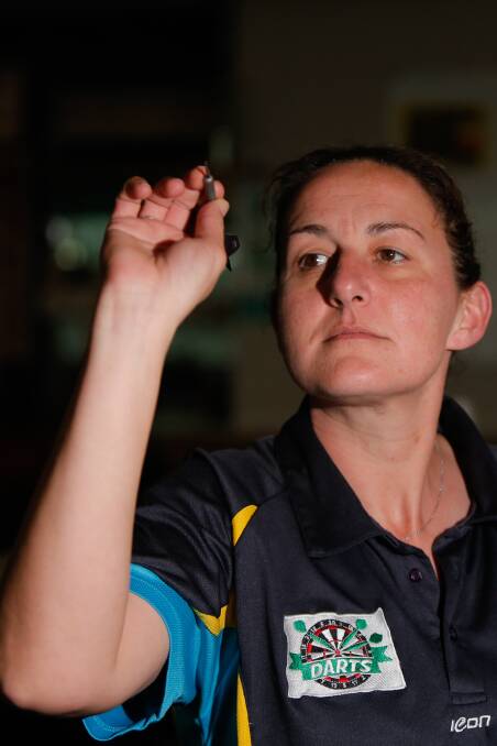 Focused: Warrnambool Darts Association committee member Christine Huismann throws a dart. Picture: Mark Witte
