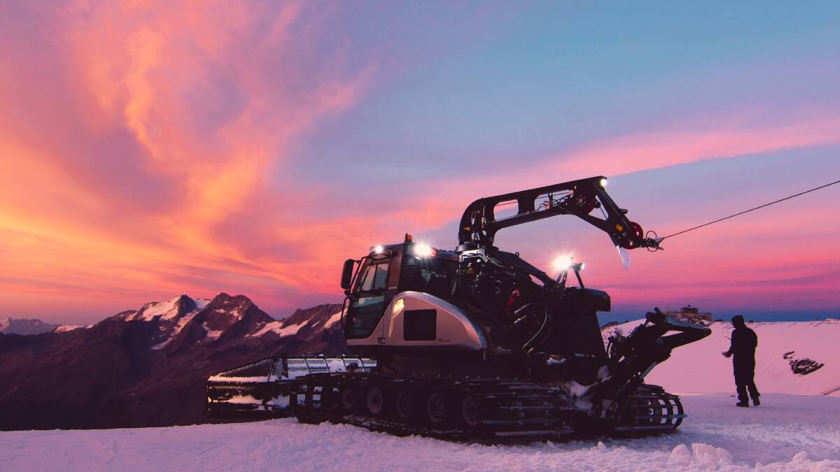 A snowcat at work building a terrain park in Switzerland