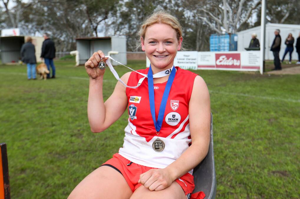 TOUGH: South Warrnambool's Jane McMeel holds up her best on ground medal, she ended the game with an injury. Picture: Morgan Hancock