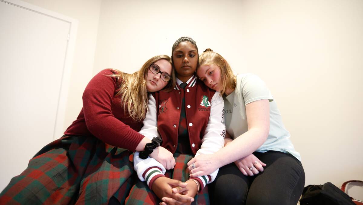SUPPORT: Vanisre Rajasegaran is consoled by her school friends Hannah Wilson- Blake and Zoe Edwards. Picture: Mark Witte