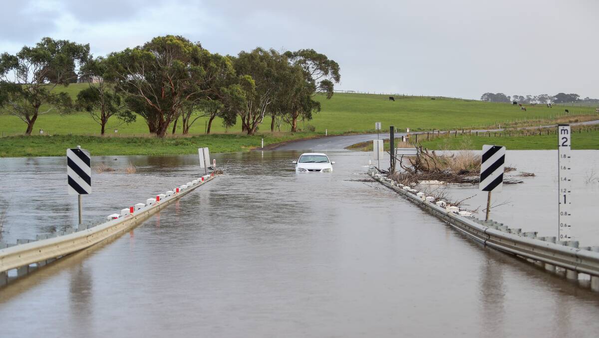 Definitely, definitely in drought: A car got stuck in rising waters on Nicols Bridge which crosses over the Merri River, near Grassmere, in August. Picture: Morgan Hancock
