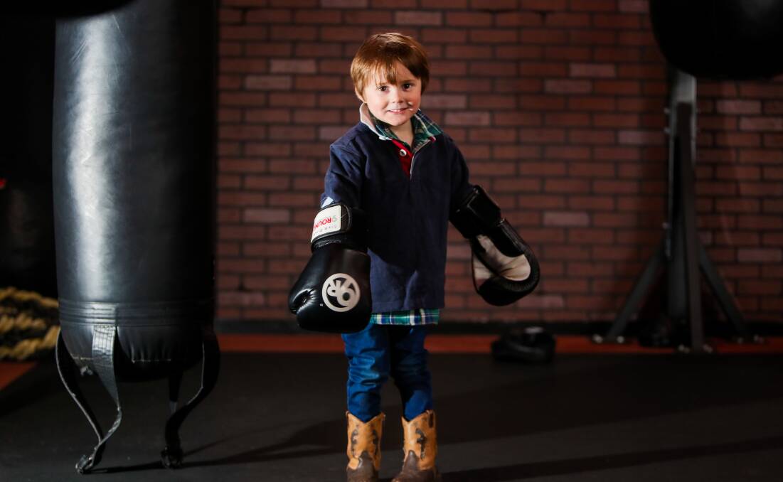 Fighting his allergies: Angus Marney, 4, tries his hand at some boxing at 9Round Warrnambool who is raising money for him to go overseas to receive treatment for his allergies. Picture: Morgan Hancock