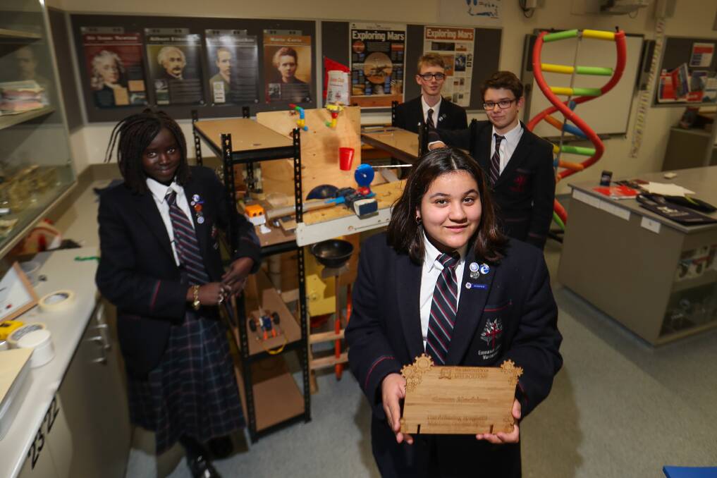 Dahlia Manytuil, 14, Diana Fernandez, 13 (holding sign), 13, Max Rea, 15, and Dom McElgunn, 16, show off their prize winning creation. Picture: Morgan Hancock