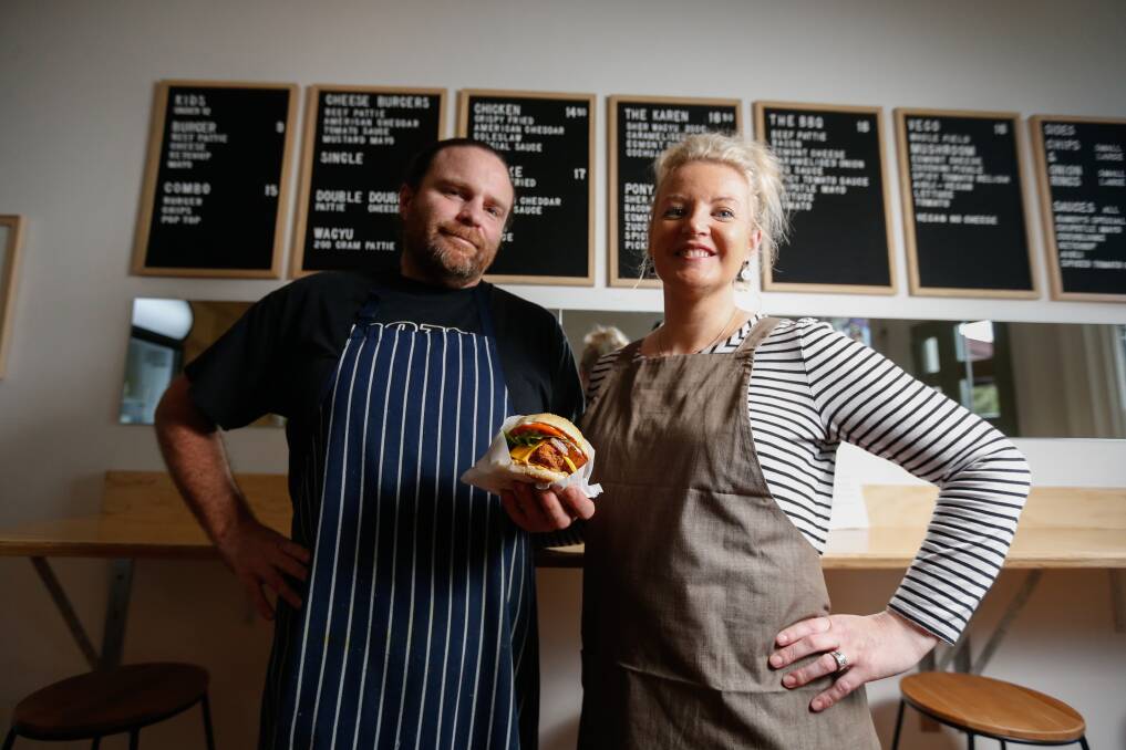 MOUTH WATERING: Ryan and Kirstyn Sessions behind a menu display that includes nine different burgers with handmade patties and locally sourced buns. Picture: Mark Witte