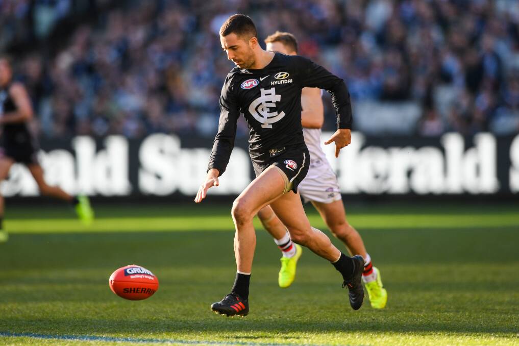 Out and running: Carlton's Kade Simpson bounces while dashing away from a St Kilda player. Picture: Morgan Hancock